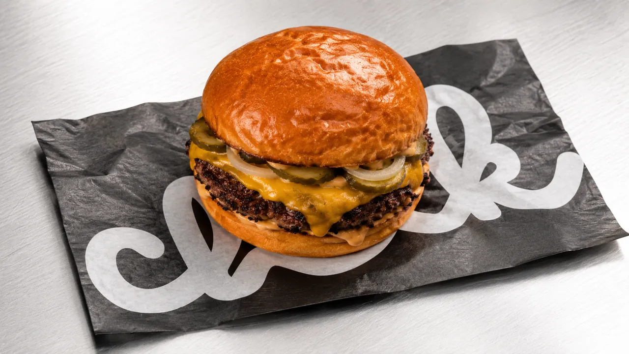 Chik double cheeseburger on branded wrapping paper